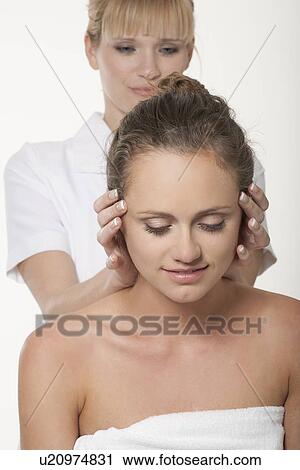 Stock Image - Smiling woman having scalp massage. Fotosearch