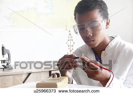 Stock Image - Student working in science lab. Fotosearch