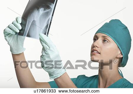 Stock Image - Surgeon examining x-rays. Fotosearch