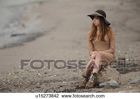 Teenage girl sitting on sandy beach View Large Photo Image Stock Image - Teenage girl sitting on sandy beach. Fotosearch
