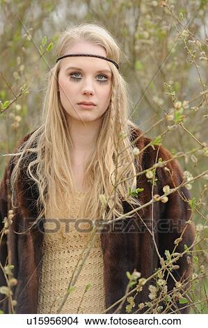 Picture - Teenage girl standing in forest. Fotosearch