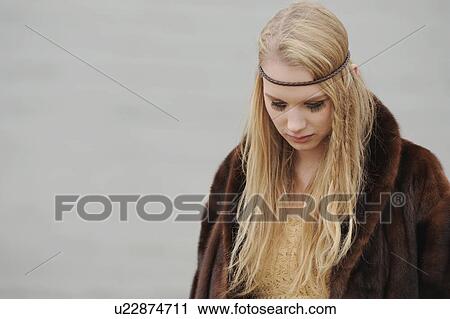 Stock Image - Teenage girl standing in forest. Fotosearch
