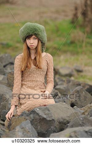 Stock Photography - Teenage girl wearing fur hat outdoors. Fotosearch
