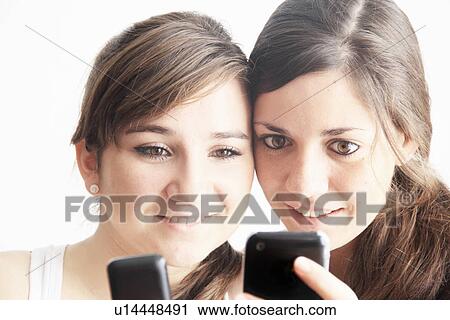 Teenage girls using cell phones View Large Photo Image Stock Image - Teenage girls using cell phones. Fotosearch