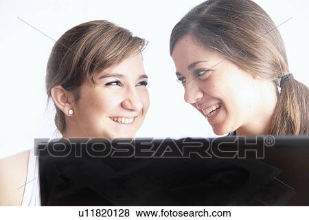 Teenage girls using laptop together View Large Photo Image Stock Photo - Teenage girls using laptop together. Fotosearch