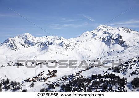 Trees and ski slopes on snowy mountains View Large Photo Image Stock Photo - Trees and ski slopes on snowy mountains. Fotosearch