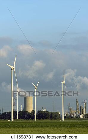 Wind turbines with nuclear smokestack View Large Photo Image Stock Image - Wind turbines with nuclear smokestack. Fotosearch