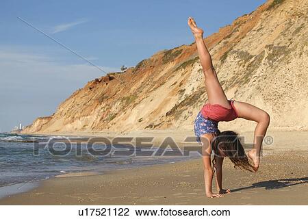 Woman doing gymnastics on beach View Large Photo Image Stock Image - Woman doing gymnastics on beach. Fotosearch