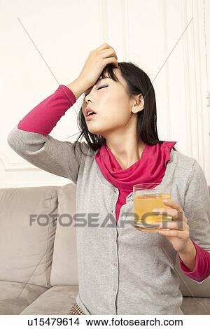 Woman drinking juice on couch View Large Photo Image Picture - Woman drinking juice on couch. Fotosearch