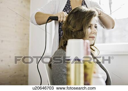 Woman having hair styled View Large Photo Image Stock Image - Woman having hair styled. Fotosearch