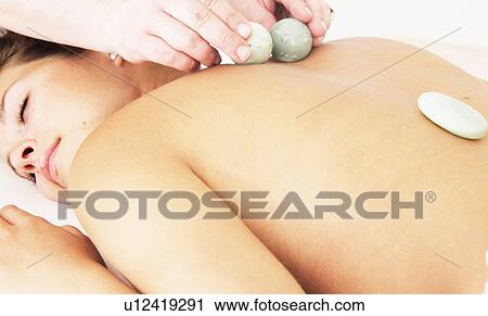 Woman having hot stone massage in spa View Large Photo Image Stock Image - Woman having hot stone massage in spa. Fotosearch