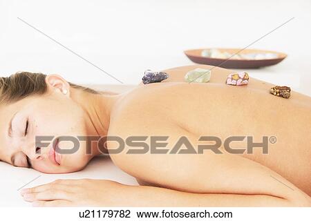 Woman having hot stone massage in spa View Large Photo Image Stock Image - Woman having hot stone massage in spa. Fotosearch