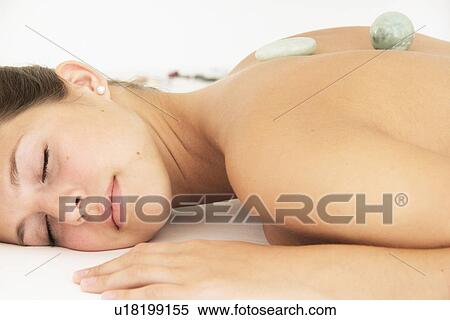 Stock Photography - Woman having hot stone massage in spa. Fotosearch
