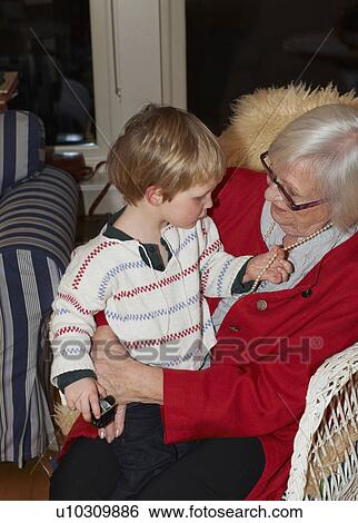 Woman holding grandson on lap View Large Photo Image Stock Photograph - Woman holding grandson on lap. Fotosearch