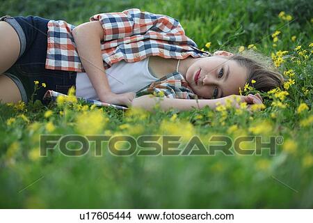 Woman laying in field of flowers View Large Photo Image Picture - Woman laying in field of flowers. Fotosearch