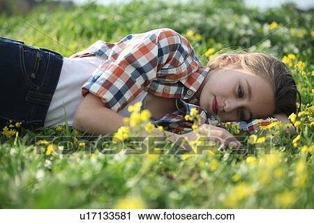 Woman laying in field of flowers View Large Photo Image Stock Image - Woman laying in field of flowers. Fotosearch