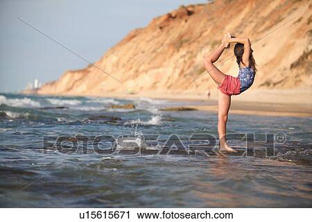 Woman practicing yoga on beach View Large Photo Image Stock Image - Woman practicing yoga on beach. Fotosearch