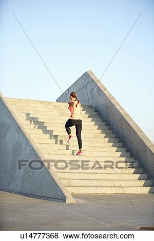 Woman running on staircase View Large Photo Image Stock Photo - Woman running on staircase. Fotosearch