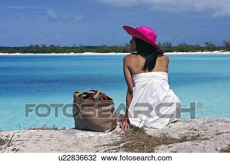 Woman sitting on tropical beach View Large Photo Image Stock Image - Woman sitting on tropical beach. Fotosearch