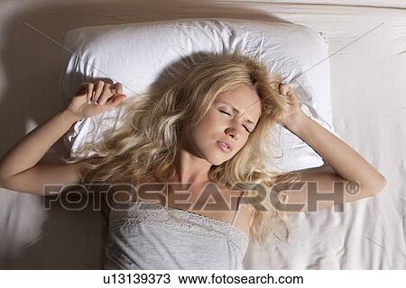 Woman sleeping fitfully in bed View Large Photo Image Stock Image - Woman sleeping fitfully in bed. Fotosearch