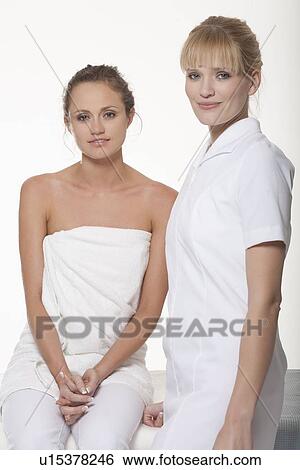 Stock Photograph - Woman smiling with massage therapist. Fotosearch