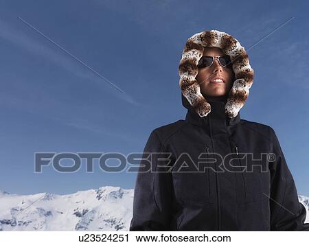 Woman wearing parka in snow View Large Photo Image Stock Image - Woman wearing parka in snow. Fotosearch