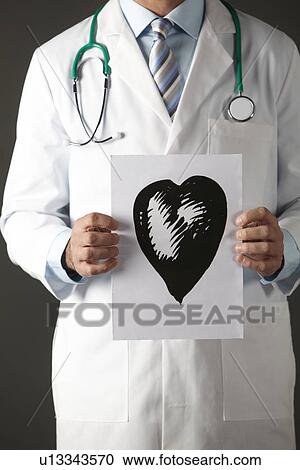 American doctor holding ink drawing of heart View Large Photo Image Stock Image - American doctor holding ink drawing of heart. Fotosearch