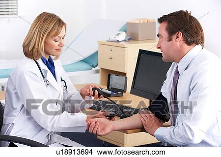American doctor taking patient's blood pressure View Large Photo Image Picture - American doctor taking patient's blood pressure. Fotosearch