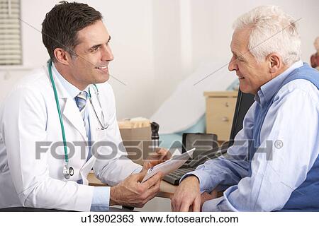 American doctor talking to senior man in surgery View Large Photo Image Stock Image - American doctor talking to senior man in surgery. Fotosearch