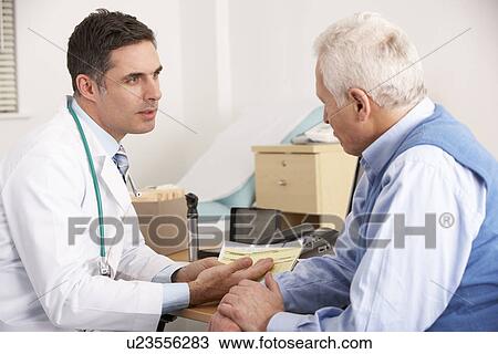 American doctor talking to senior man in surgery View Large Photo Image Stock Image - American doctor talking to senior man in surgery. Fotosearch
