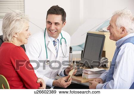 American doctor talking to senior couple in surgery View Large Photo Image Stock Photo - American doctor talking to senior couple in surgery. Fotosearch