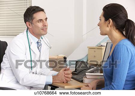 American doctor talking to woman in surgery View Large Photo Image Picture - American doctor talking to woman in surgery. Fotosearch