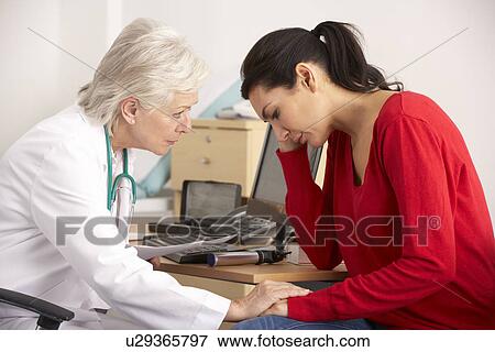 Stock Photo - American doctor with depressed woman patient. Fotosearch