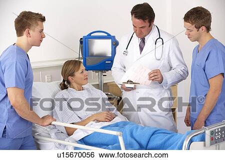 Stock Photograph - American medical team by patient's bed. Fotosearch