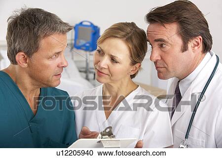 Stock Image - American medical team working on hospital ward. Fotosearch