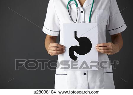 Picture - American nurse holding ink drawing stomach. Fotosearch