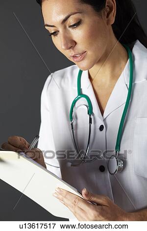 Stock Photo - American nurse with stethoscope and clipboard. Fotosearch