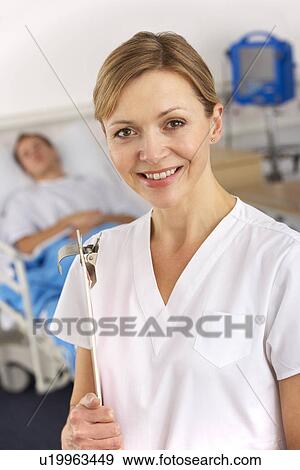Stock Photo - American nurse working on hospital ward. Fotosearch