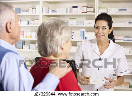 American pharmacist dispensing to senior couple View Large Photo Image Picture - American pharmacist dispensing to senior couple. Fotosearch
