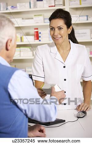 American pharmacist dispensing to senior man View Large Photo Image Stock Photography - American pharmacist dispensing to senior man. Fotosearch
