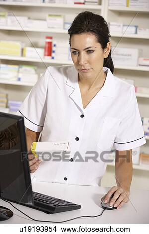 American pharmacist using computer in pharmacy View Large Photo Image Picture - American pharmacist using computer in pharmacy. Fotosearch