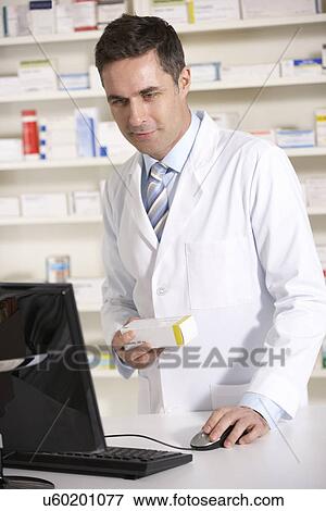 American pharmacist working on computer View Large Photo Image Stock Photo - American pharmacist working on computer. Fotosearch