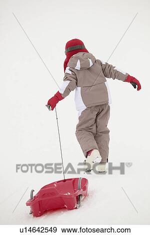 Back View Young Girl Pulling Sledge On Ski Holiday In Mountains View Large Photo Image Stock Photo - Back View Young Girl Pulling Sledge On Ski Holiday In Mountains. Fotosearch