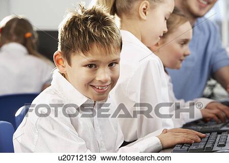 Boy in school class smiling to camera View Large Photo Image Stock Photo - Boy in school class smiling to camera. Fotosearch