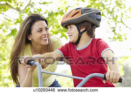 Boy on bike with mother View Large Photo Image Stock Photograph - Boy on bike with mother. Fotosearch