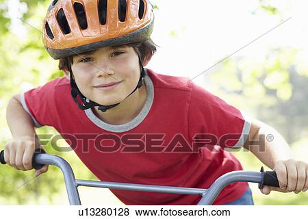 Boy riding bike View Large Photo Image Stock Photo - Boy riding bike. Fotosearch