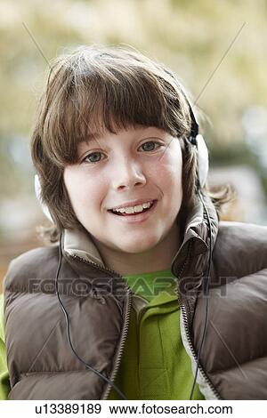 Boy Wearing Headphones And Listening To Music Wearing Winter Clothes View Large Photo Image Stock Photo - Boy Wearing Headphones And Listening To Music Wearing Winter Clothes. Fotosearch