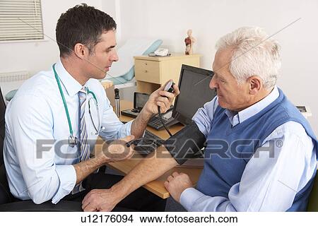 Picture - British doctor taking senior man's blood pressure. Fotosearch