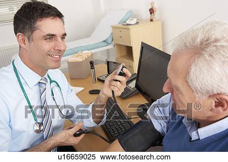British doctor taking senior man's blood pressure View Large Photo Image Stock Photography - British doctor taking senior man's blood pressure. Fotosearch