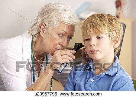 British GP examining young boy's ear View Large Photo Image Stock Photograph - British GP examining young boy's ear. Fotosearch